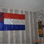 A Karen flag hung on the wall of a migrants' home.