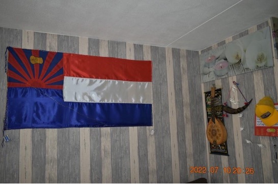 A Karen flag hung on the wall of a migrants' home.